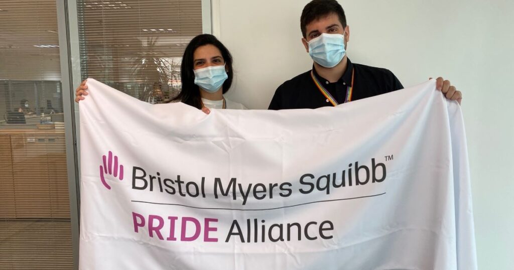 Brazilian employees holding a Pride Alliance banner