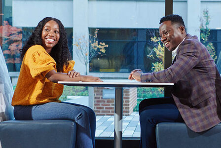 two colleagues sitting at a lunch table