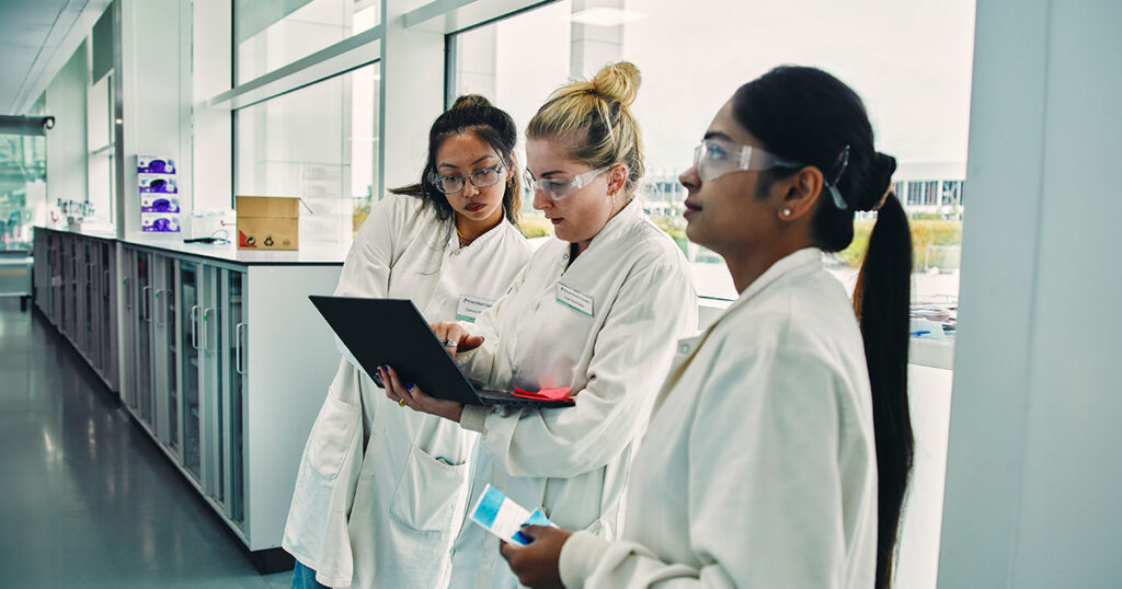 Three female scientists in BMS facility