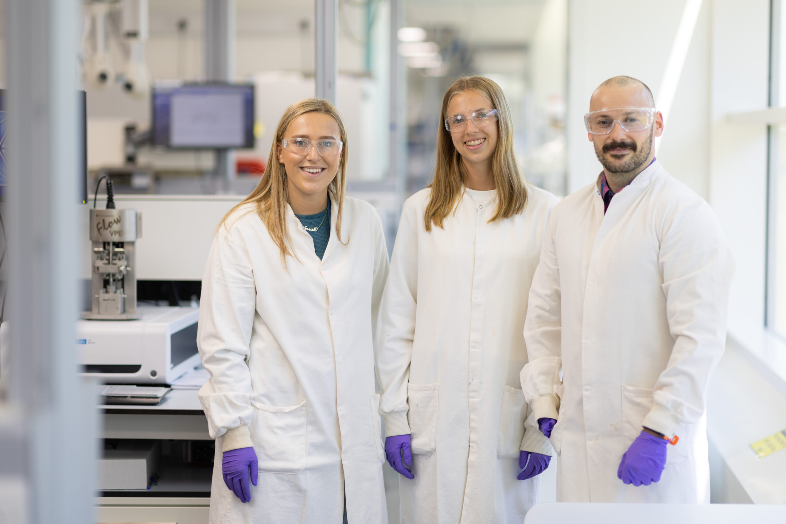 Photo of three employees in a lab