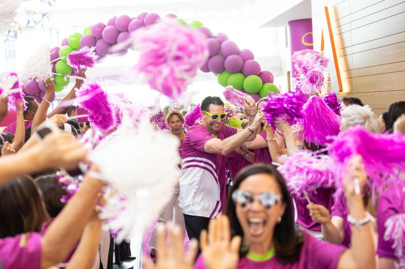 Photo of employees waving and celebrating