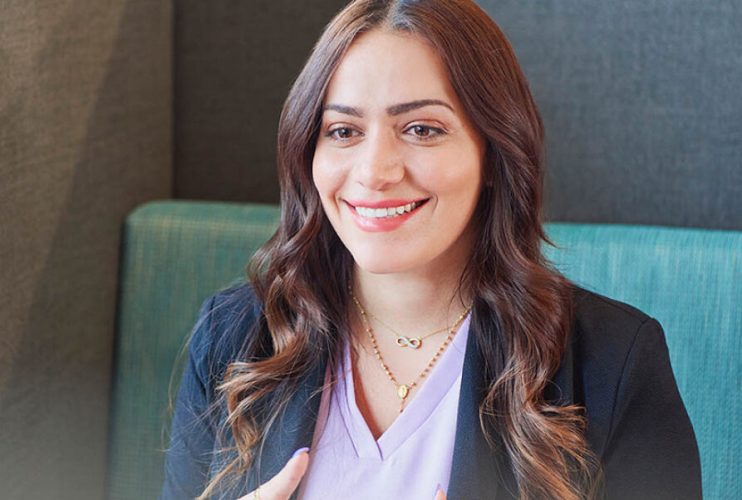 woman sitting in a booth smiling